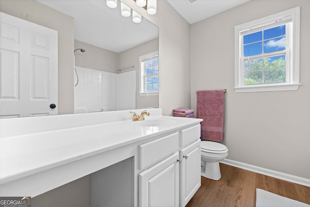 full bathroom with toilet, baseboards, plenty of natural light, and wood finished floors