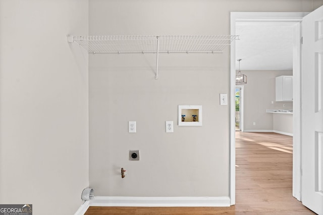 laundry room featuring laundry area, electric dryer hookup, light wood-type flooring, baseboards, and hookup for a washing machine