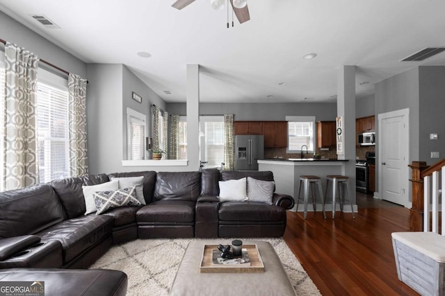 9988 Devonshire St, Douglasville, GA 30135 - living area with dark wood-type flooring, ceiling fan, and visible vents