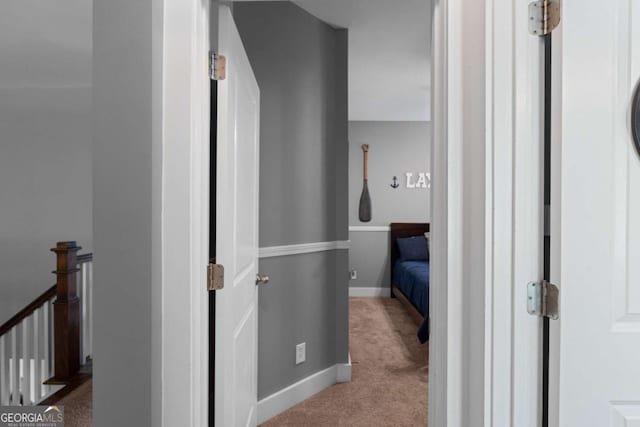 9988 Devonshire St, Douglasville, GA 30135 - hallway featuring baseboards, carpet, and an upstairs landing