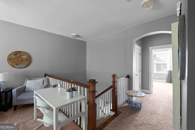 9988 Devonshire St, Douglasville, GA 30135 - hall featuring carpet flooring, arched walkways, baseboards, and an upstairs landing