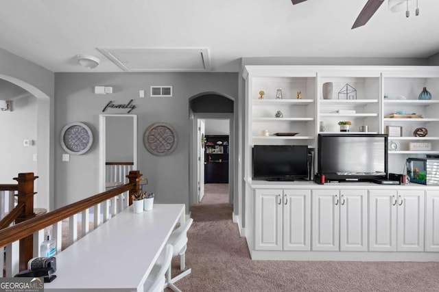 9988 Devonshire St, Douglasville, GA 30135 - living area featuring visible vents, light carpet, attic access, arched walkways, and a ceiling fan