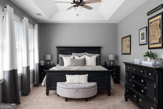 9988 Devonshire St, Douglasville, GA 30135 - bedroom with a ceiling fan, visible vents, light carpet, and a raised ceiling