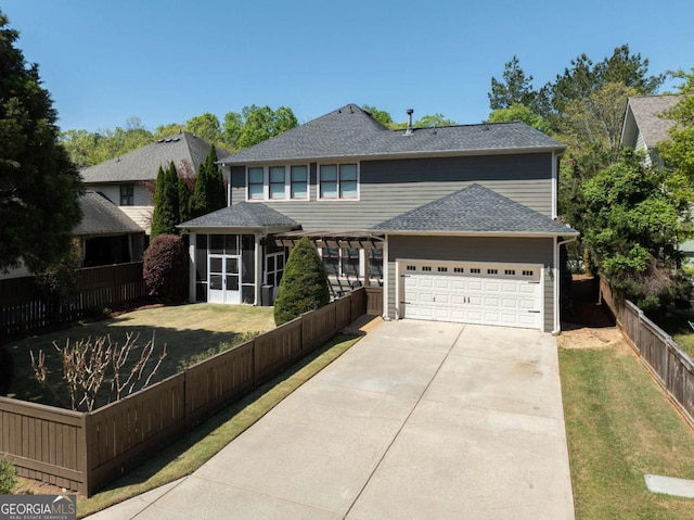 9988 Devonshire St, Douglasville, GA 30135 - traditional home featuring a garage, a sunroom, driveway, and a front yard