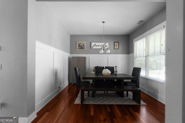 9988 Devonshire St, Douglasville, GA 30135 - dining area featuring wood finished floors, a decorative wall, visible vents, and a wainscoted wall