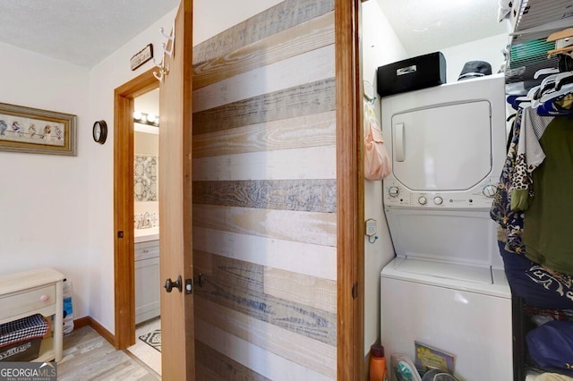 329 Ed King Rd, Blairsville, GA 30512 - laundry room featuring light wood-type flooring, stacked washer / dryer, and laundry area