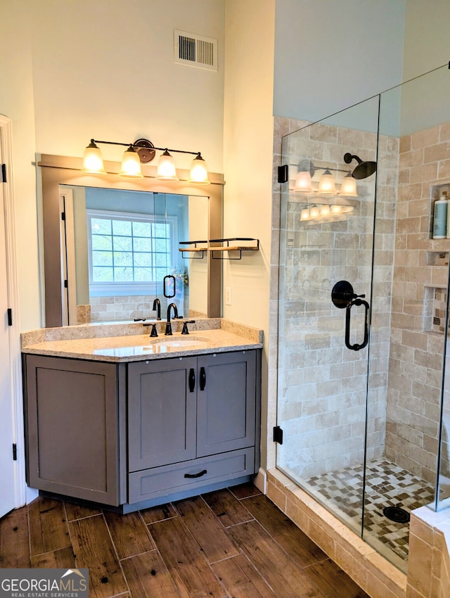 1581 Shetland Pony Ct NW, Suwanee, GA 30024 - bathroom featuring a stall shower, wood tiled floors, and vanity