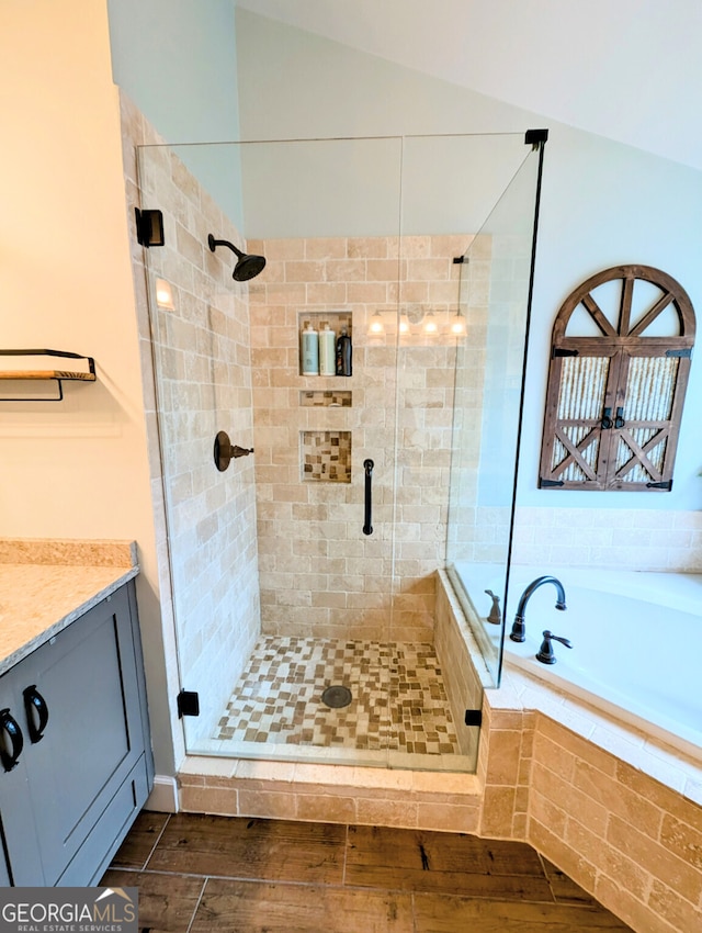 1581 Shetland Pony Ct NW, Suwanee, GA 30024 - full bath with a stall shower, wood finished floors, a garden tub, and vanity