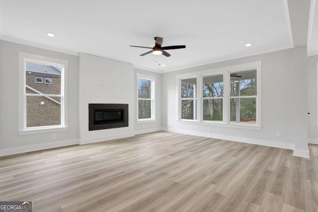 unfurnished living room with light wood-type flooring, ceiling fan, a fireplace, baseboards, and recessed lighting