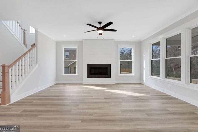 unfurnished living room with ceiling fan, baseboards, stairs, and light wood-style flooring