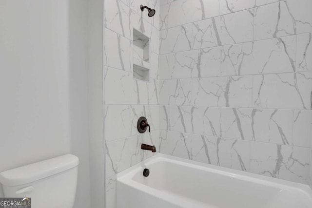 bathroom featuring washtub / shower combination and toilet