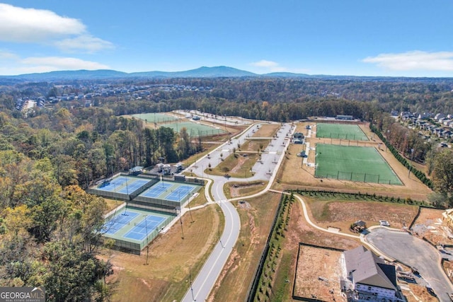 drone / aerial view featuring a forest view and a mountain view