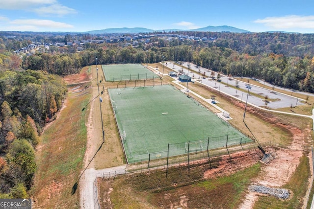 drone / aerial view featuring a view of trees and a mountain view