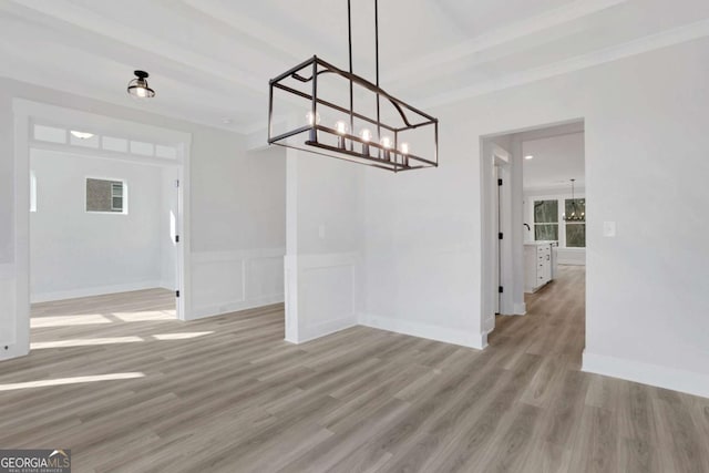 unfurnished dining area with light wood finished floors, baseboards, and a chandelier