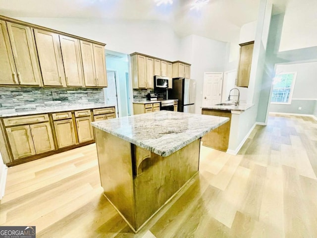 7675 Lanier View Rdg, Cumming, GA 30041 - kitchen with appliances with stainless steel finishes, light wood-style flooring, tasteful backsplash, high vaulted ceiling, and light stone counters