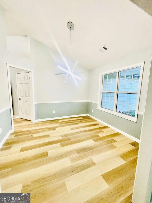 7675 Lanier View Rdg, Cumming, GA 30041 - unfurnished dining area featuring wood finished floors and vaulted ceiling
