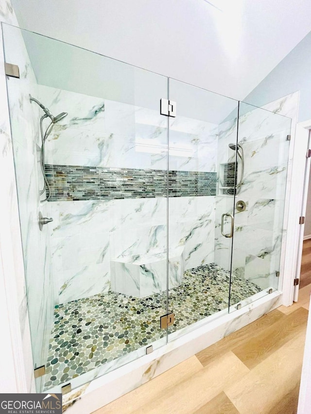 7675 Lanier View Rdg, Cumming, GA 30041 - bathroom with a marble finish shower and wood finished floors