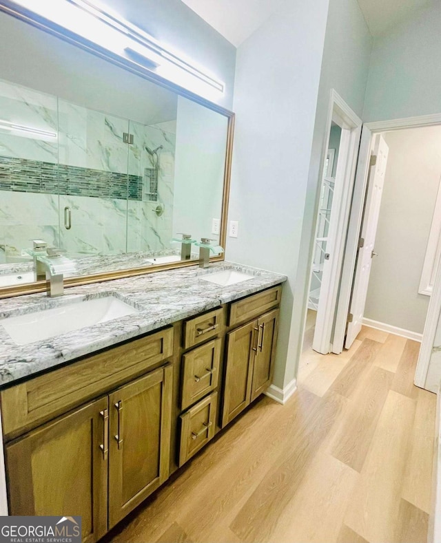 7675 Lanier View Rdg, Cumming, GA 30041 - bathroom with wood finished floors, double vanity, and a marble finish shower