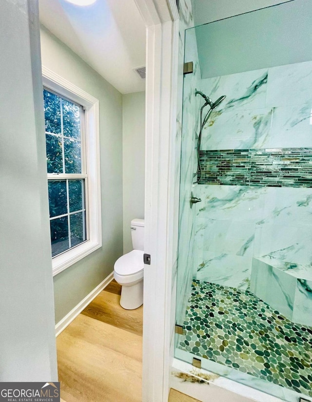 7675 Lanier View Rdg, Cumming, GA 30041 - full bathroom with a marble finish shower and wood finished floors