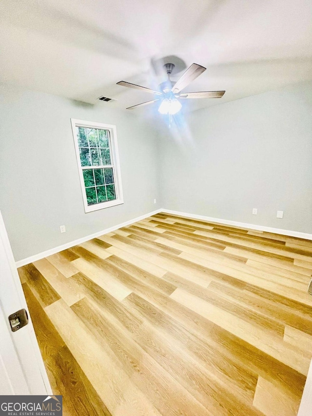 7675 Lanier View Rdg, Cumming, GA 30041 - unfurnished room featuring wood finished floors, a ceiling fan, and baseboards