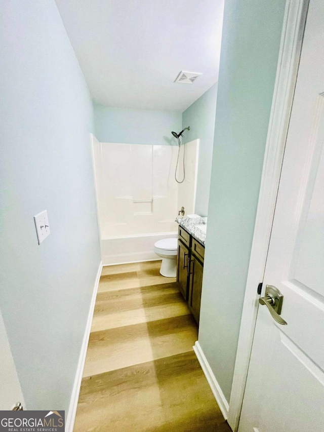 7675 Lanier View Rdg, Cumming, GA 30041 - bathroom with wood finished floors, vanity, and shower / tub combination