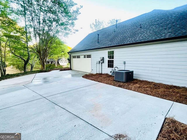 7675 Lanier View Rdg, Cumming, GA 30041 - back of property with concrete driveway, roof with shingles, and an attached garage