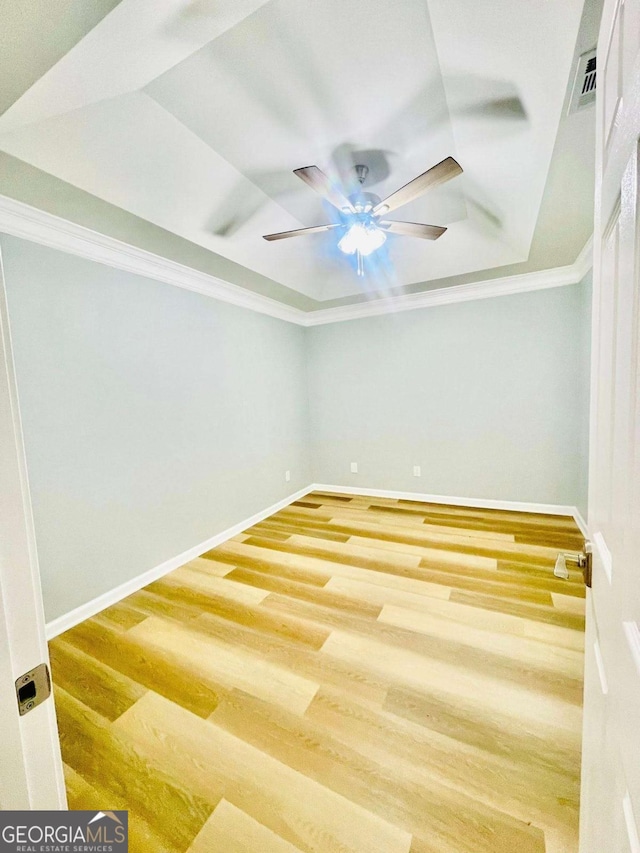 7675 Lanier View Rdg, Cumming, GA 30041 - unfurnished room with ornamental molding, a raised ceiling, wood finished floors, and ceiling fan