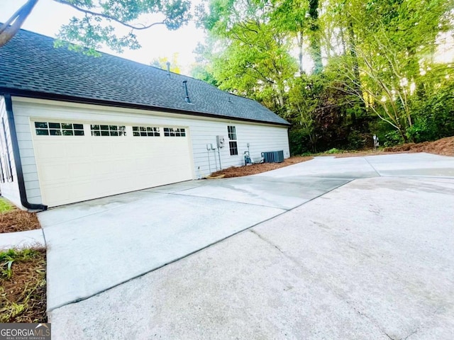 7675 Lanier View Rdg, Cumming, GA 30041 - view of property exterior featuring roof with shingles, a garage, and driveway