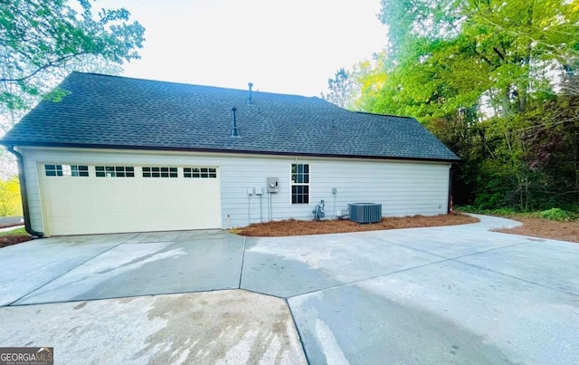 7675 Lanier View Rdg, Cumming, GA 30041 - back of house with roof with shingles, cooling unit, and driveway