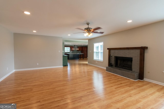 5 Gibson Rd, Newnan, GA 30263 - unfurnished living room featuring a brick fireplace, recessed lighting, light wood-style flooring, a ceiling fan, and baseboards