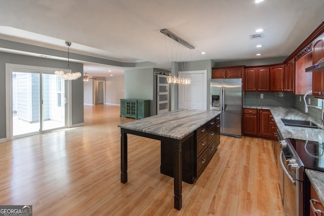 5 Gibson Rd, Newnan, GA 30263 - kitchen with appliances with stainless steel finishes, a chandelier, a sink, light wood-style flooring, and tasteful backsplash