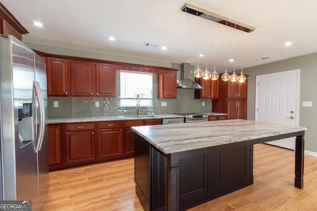 5 Gibson Rd, Newnan, GA 30263 - kitchen featuring stainless steel appliances, wall chimney exhaust hood, a sink, light wood-style flooring, and backsplash