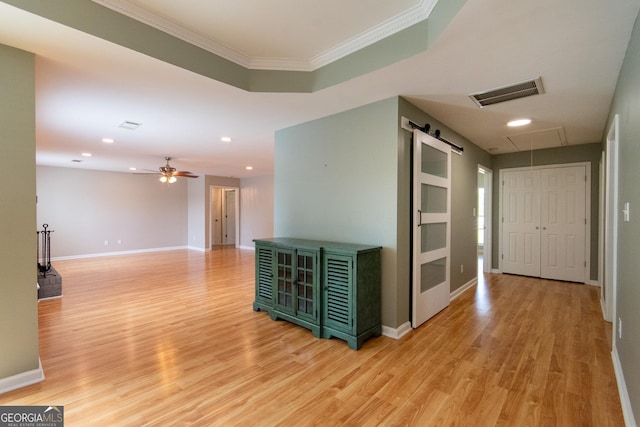 5 Gibson Rd, Newnan, GA 30263 - hall with ornamental molding, light wood finished floors, baseboards, a barn door, and attic access