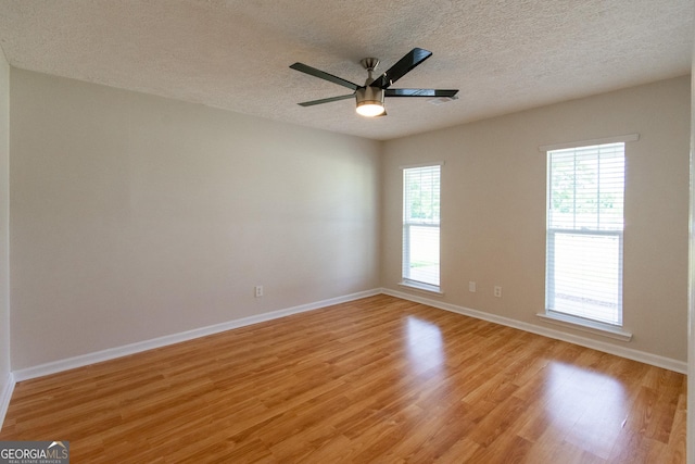 5 Gibson Rd, Newnan, GA 30263 - empty room with light wood-style flooring, a textured ceiling, baseboards, and a ceiling fan