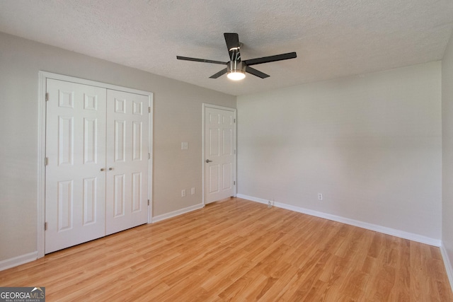 5 Gibson Rd, Newnan, GA 30263 - unfurnished bedroom featuring light wood finished floors, baseboards, a textured ceiling, a closet, and ceiling fan