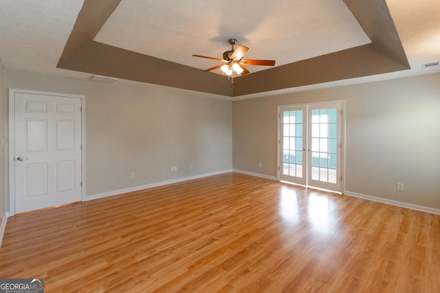 5 Gibson Rd, Newnan, GA 30263 - spare room featuring a ceiling fan, baseboards, a raised ceiling, and light wood-style floors
