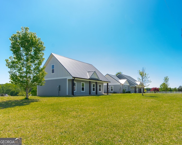 5 Gibson Rd, Newnan, GA 30263 - view of front of property with a front lawn, metal roof, board and batten siding, and a standing seam roof
