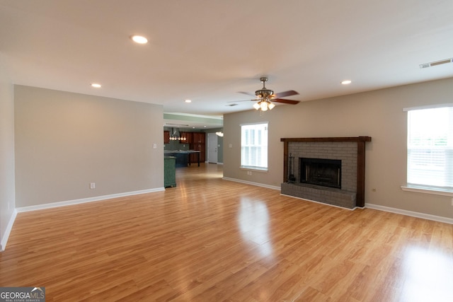 5 Gibson Rd, Newnan, GA 30263 - unfurnished living room featuring a brick fireplace, light wood-style flooring, baseboards, ceiling fan, and recessed lighting