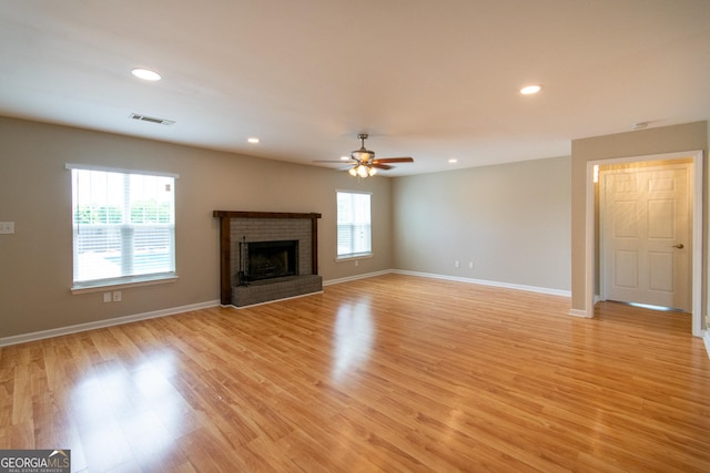 5 Gibson Rd, Newnan, GA 30263 - unfurnished living room with a brick fireplace, light wood-type flooring, baseboards, recessed lighting, and ceiling fan
