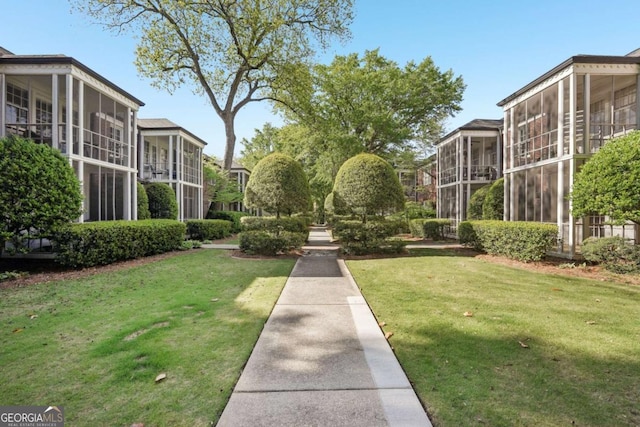 view of property's community with a yard