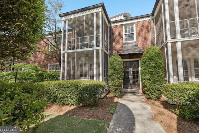 55 Delmont Dr NE Unit D1, Atlanta, GA 30305 - view of front of home featuring french doors, brick siding, and a sunroom