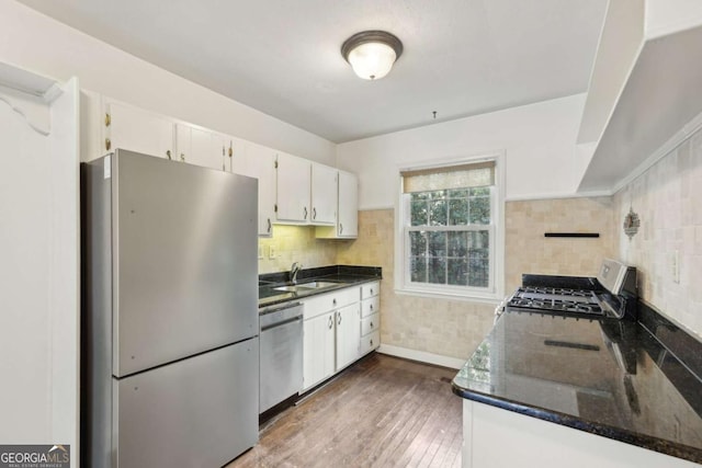 55 Delmont Dr NE Unit D1, Atlanta, GA 30305 - kitchen featuring stainless steel appliances, dark wood-type flooring, backsplash, white cabinets, and dark stone countertops