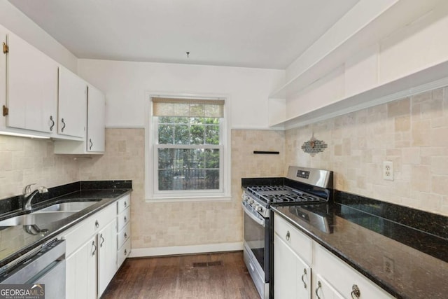 55 Delmont Dr NE Unit D1, Atlanta, GA 30305 - kitchen featuring stainless steel appliances, white cabinetry, dark wood finished floors, and dark stone counters