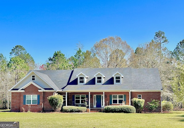 2101 Hendrix Rd, Brooklet, GA 30415 - view of front of home with covered porch, brick siding, and a front yard