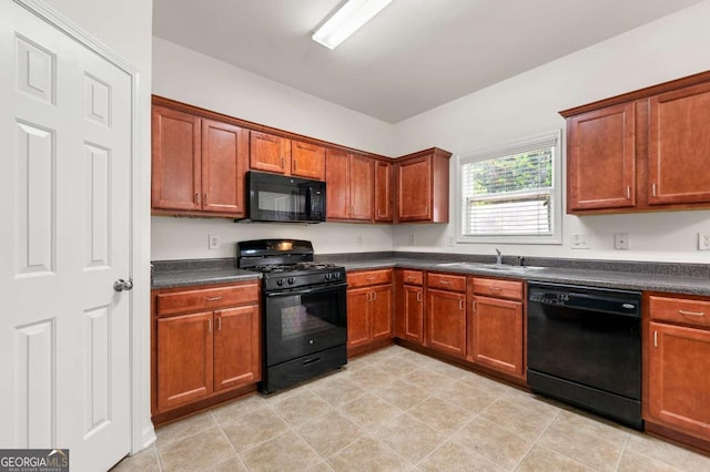 2060 Executive Dr, Duluth, GA 30096 - kitchen featuring black appliances, a sink, dark countertops, and brown cabinetry