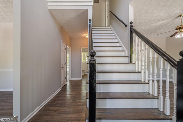 1331 Windage Ct SW, Marietta, GA 30008 - stairs with a textured ceiling, a ceiling fan, and wood finished floors