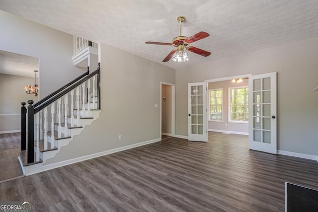 1331 Windage Ct SW, Marietta, GA 30008 - unfurnished living room with french doors, dark wood finished floors, a textured ceiling, stairway, and ceiling fan