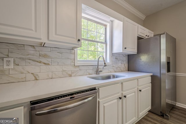 1331 Windage Ct SW, Marietta, GA 30008 - kitchen with stainless steel appliances, white cabinetry, light countertops, dark wood-style floors, and crown molding