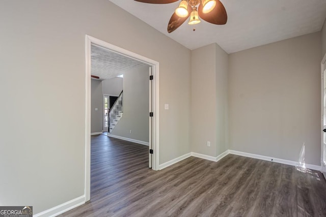 1331 Windage Ct SW, Marietta, GA 30008 - unfurnished room featuring ceiling fan, stairs, and dark wood-type flooring
