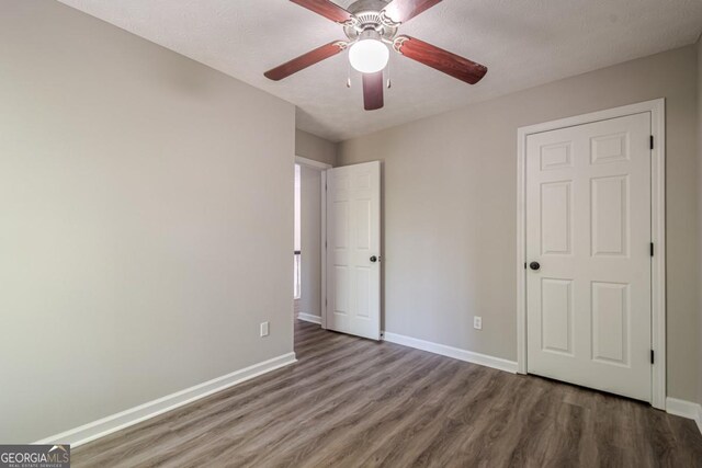 1331 Windage Ct SW, Marietta, GA 30008 - unfurnished bedroom with wood finished floors and ceiling fan